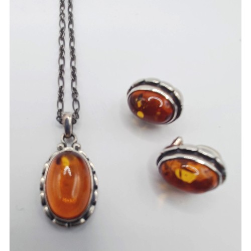 1711 - A Georg Jensen silver and amber coloured stone pendant, on a chain, and a pair of matching earrings ... 