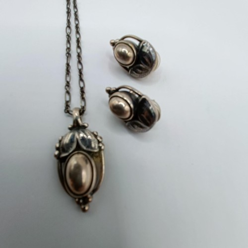 1713 - A Georg Jensen silver pendant, decorated leaves, and a pair of matching earrings, 27.2 g, in a Georg... 