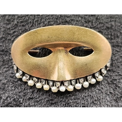 1730 - A yellow metal and seed pearl novelty brooch, in the form of a theatrical mask