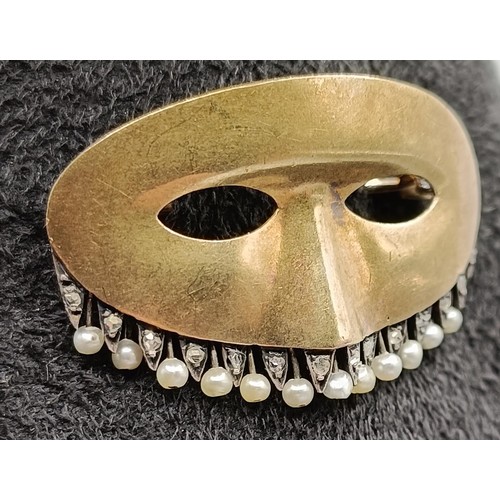 1730 - A yellow metal and seed pearl novelty brooch, in the form of a theatrical mask