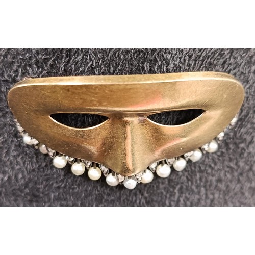 1730 - A yellow metal and seed pearl novelty brooch, in the form of a theatrical mask