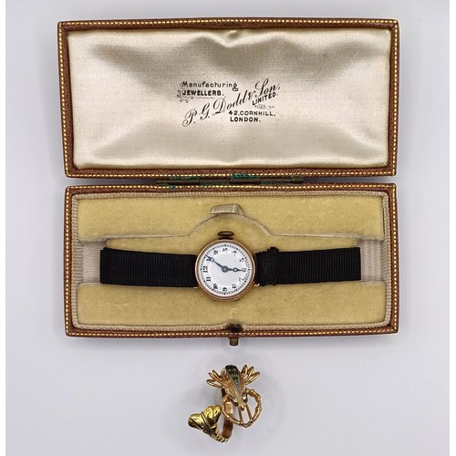 1756 - A 9ct gold ladies wristwatch, on a silk strap, in a vintage jewellery box and a dress ring in the fo... 