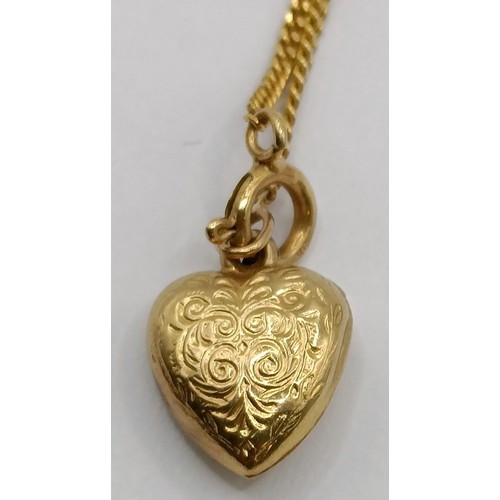 1770 - A 9ct gold chain, with a heart shaped pendant, a pair of yellow metal hoop earrings, and a micro-mos... 