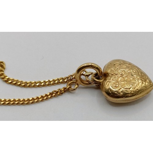 1770 - A 9ct gold chain, with a heart shaped pendant, a pair of yellow metal hoop earrings, and a micro-mos... 