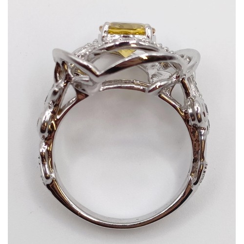 1774 - A white metal, diamond and yellow stone fancy ring, ring size M