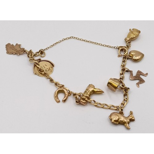 1781 - A 9ct gold chain, and assorted gold, yellow metal and silver charms