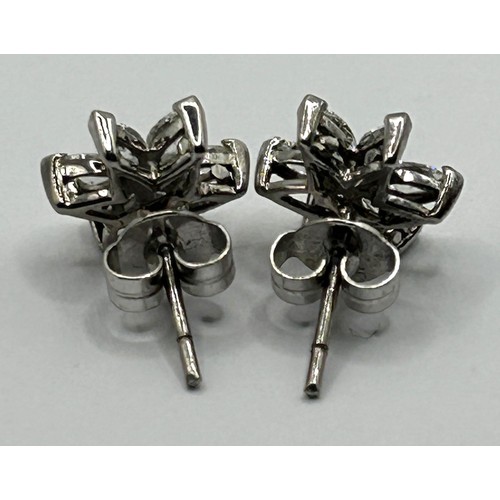 1667 - A pair of 18ct white gold and diamond snowflake earrings