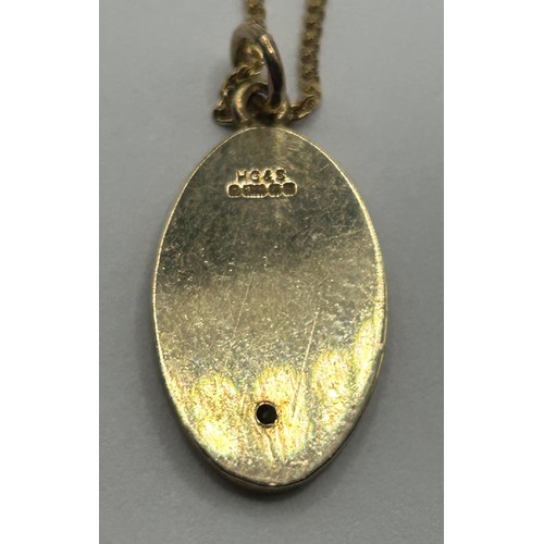 1670 - A 9ct gold and diamond oval pendant, on a chain