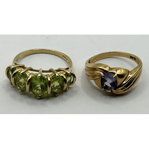 1699 - A 14ct gold and green five stone ring, ring size N, and a 10ct gold and purple stone ring, ring size... 