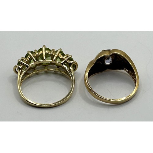 1699 - A 14ct gold and green five stone ring, ring size N, and a 10ct gold and purple stone ring, ring size... 