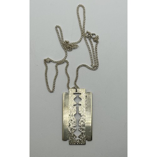 1700 - A novelty silver pendant, in the form of a razor blade