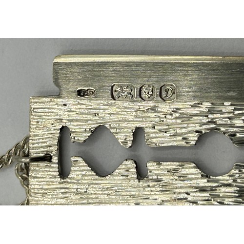 1700 - A novelty silver pendant, in the form of a razor blade