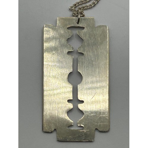 1700 - A novelty silver pendant, in the form of a razor blade