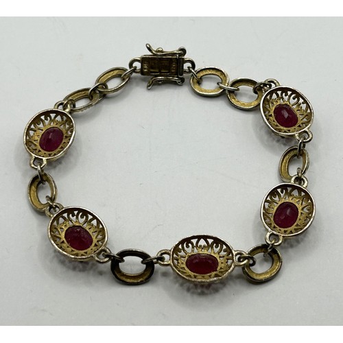 1744 - A silver gilt and red stone bracelet