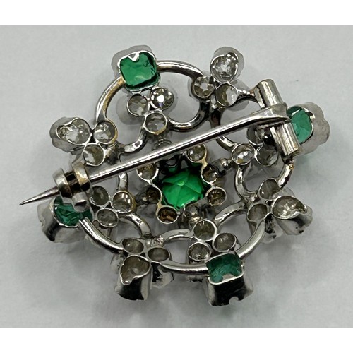 1754 - A late 19th/early 20th century 18ct white gold, diamond and emerald set brooch