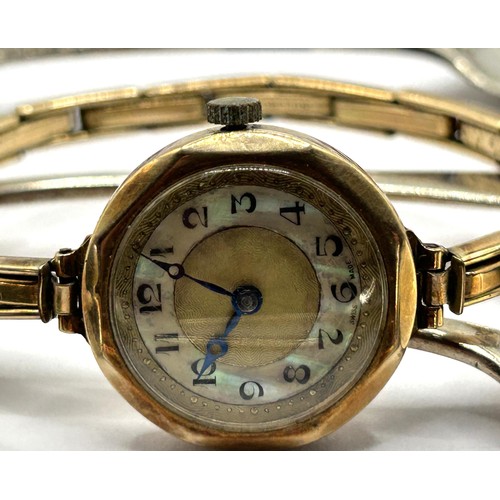 1757 - A ladies 9ct gold wristwatch, with a gold plated expandable strap, and six Old English pattern silve... 