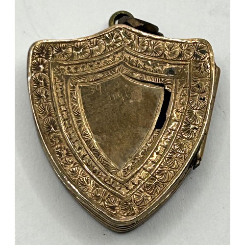 1767 - A yellow metal and hardstone, shield shaped pendant