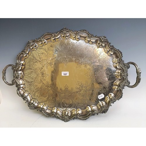 1807 - A large silver plated oval two handled tea tray, with engraved decoration, 71 cm wide