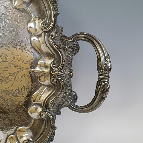 1807 - A large silver plated oval two handled tea tray, with engraved decoration, 71 cm wide