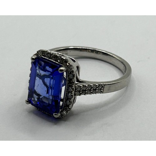 1601 - A platinum, tanzanite and diamond cluster ring, the emerald cut tanzanite approx. 4ct, ring size O1/... 