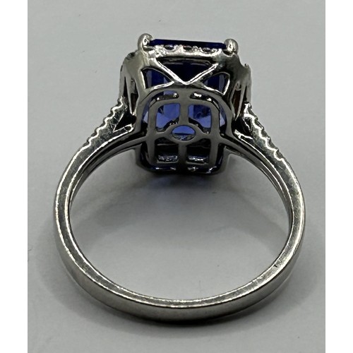 1601 - A platinum, tanzanite and diamond cluster ring, the emerald cut tanzanite approx. 4ct, ring size O1/... 