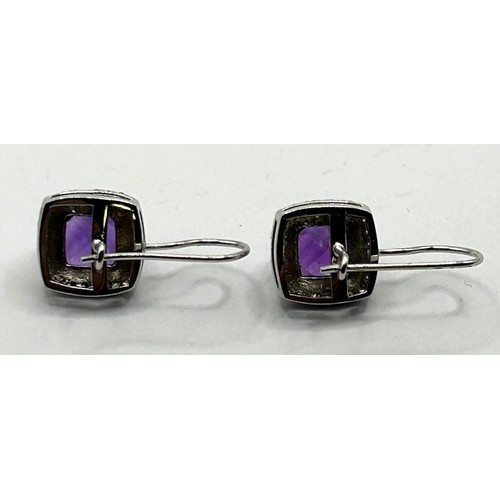 1615 - A pair of 18ct white gold, amethyst and diamond cluster earrings