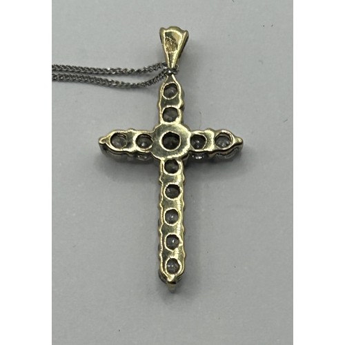 1624 - A 9ct gold and diamond cross pendant, approx. 1ct on a chain