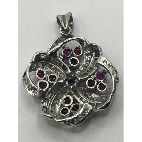 1627 - An 18ct white gold, diamond and red stone pendant