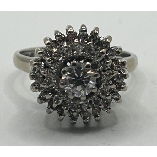 1630 - An 18ct white gold and diamond cluster ring, ring size N