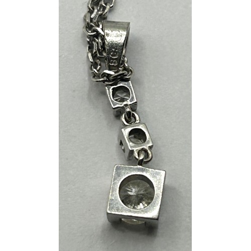 1621 - An 18ct white gold and diamond pendant, on a 14ct gold chain