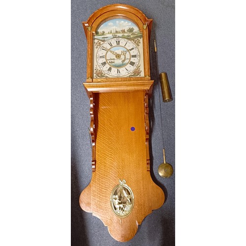 1204 - A Dutch wall clock, the painted dial with an eight day movement, in an oak case with metal mounts, 1... 