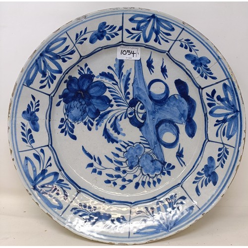 1054 - A pair of Dutch Delft blue and white plates, decorated flowers, 32 cm diameter, and another pair (4)