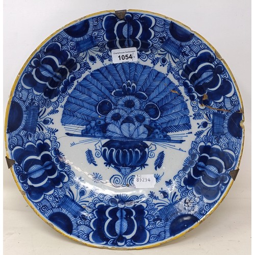 1054 - A pair of Dutch Delft blue and white plates, decorated flowers, 32 cm diameter, and another pair (4)