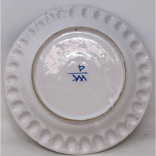 1055 - A Dutch blue and white Delft plate, 31 cm diameter, and four other Delft plates (5)