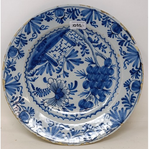 1055 - A Dutch blue and white Delft plate, 31 cm diameter, and four other Delft plates (5)