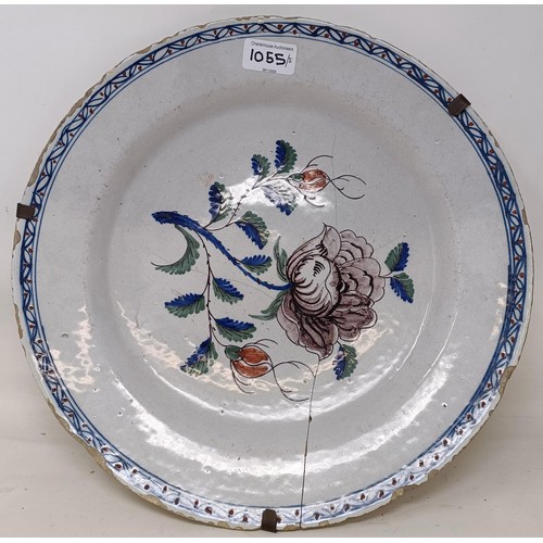 1055 - A Dutch blue and white Delft plate, 31 cm diameter, and four other Delft plates (5)