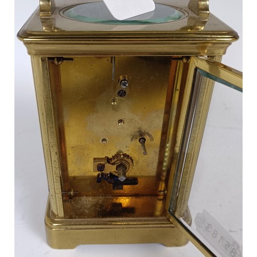 1211 - A carriage timepiece, the 6.5 cm wide enamel dial with Roman numerals, in a brass four pillar case, ... 