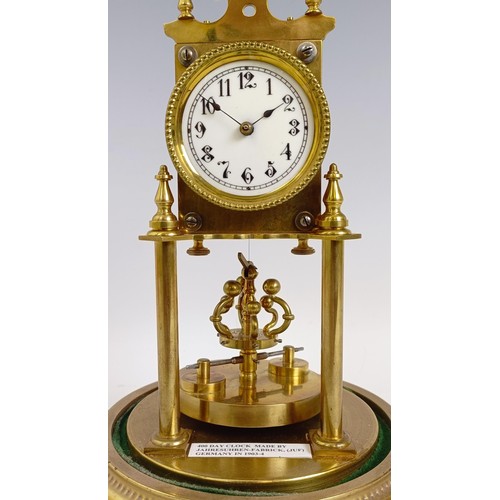 1213 - A brass 400 day anniversary clock, under a glass dome, 30 cm high