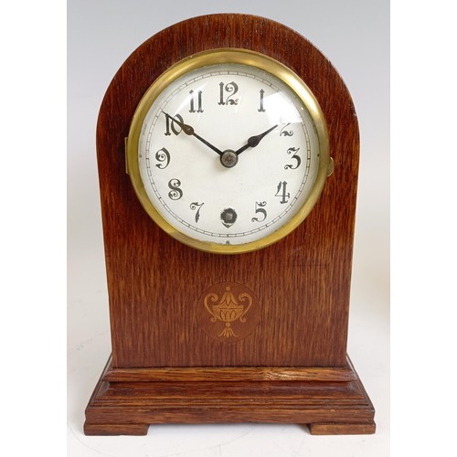 1214 - An Edwardian mantel clock, in an inlaid mahogany case, 21.5 cm high, and two others similar (3)