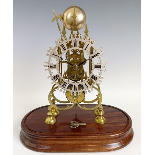 1215 - A brass skeleton clock, the 16 cm diameter silvered chapter ring with Roman numerals, under a glass ... 