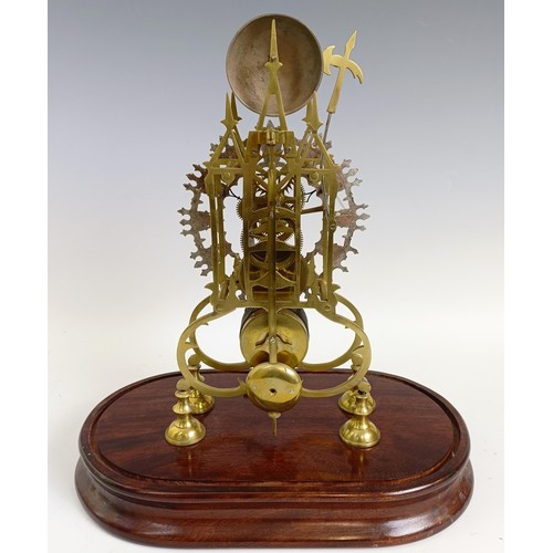 1215 - A brass skeleton clock, the 16 cm diameter silvered chapter ring with Roman numerals, under a glass ... 