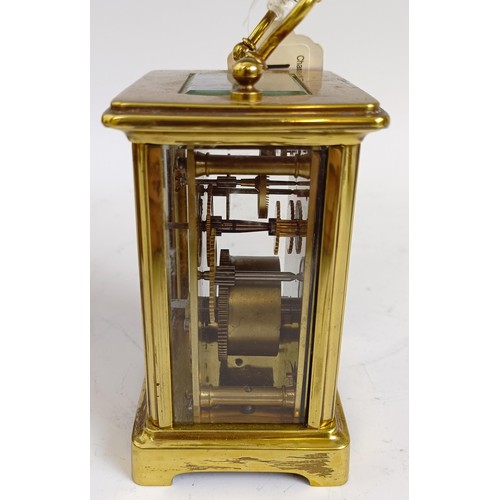 1217 - A carriage clock, with an enamel dial, in a brass case, 15 cm high, in a leather travelling case