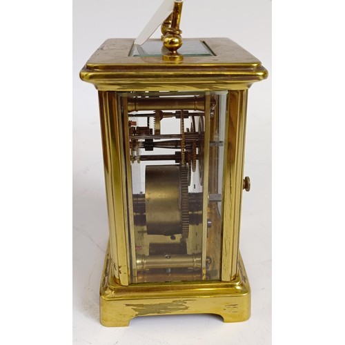 1217 - A carriage clock, with an enamel dial, in a brass case, 15 cm high, in a leather travelling case