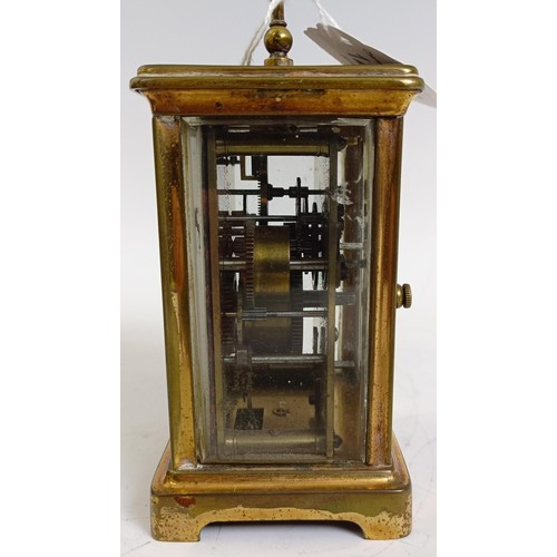 1218 - A carriage clock, with alarum, the enamel dial in a brass case, 15 cm high, in a leather travelling ... 