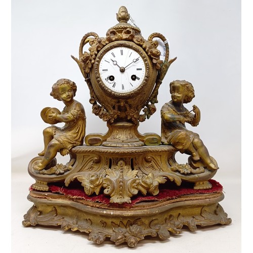 1226 - A mantel clock, in a gilt spelter figural case, on a carved wood and gesso base, 42 cm high, and a m... 