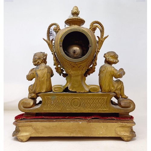 1226 - A mantel clock, in a gilt spelter figural case, on a carved wood and gesso base, 42 cm high, and a m... 