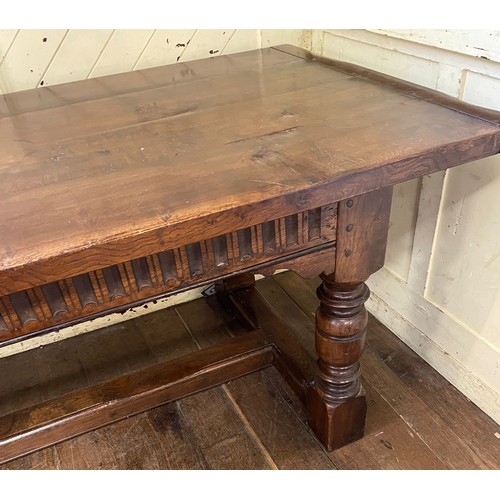 1259 - A large 18th century style oak refectory dining table, with turned legs, united by a stretcher, the ... 