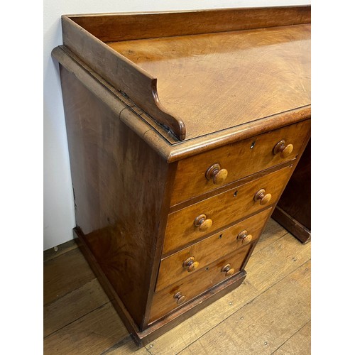 1263 - A 19th century mahogany kneehole desk, with a raised back, on two pedestals with four drawers each, ... 