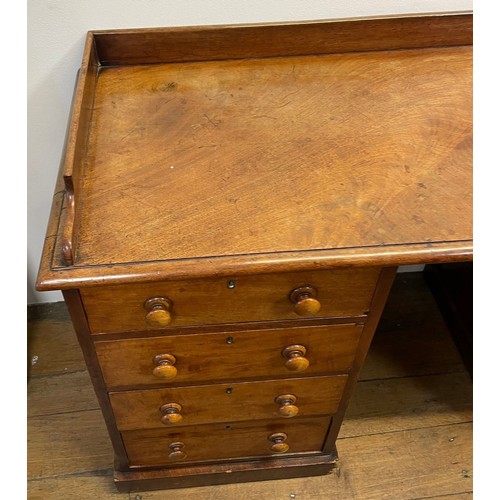 1263 - A 19th century mahogany kneehole desk, with a raised back, on two pedestals with four drawers each, ... 