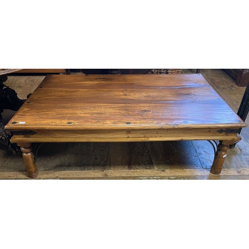 1269 - An Indian hardwood and metal bound low table, 90 x 135 cm